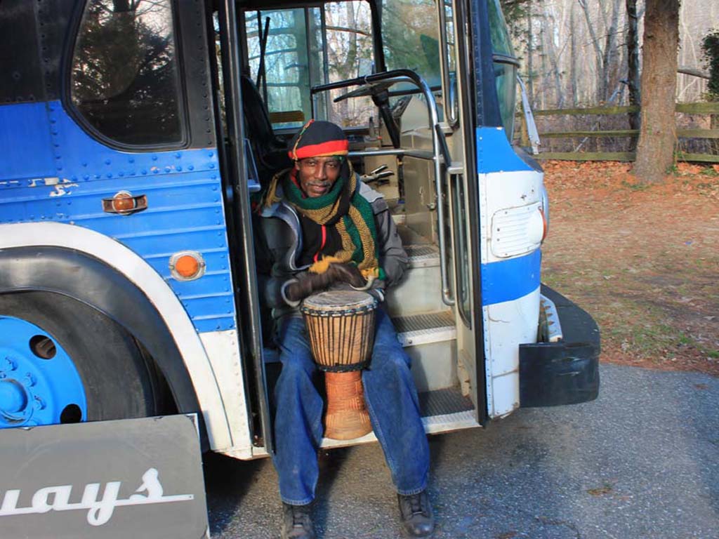 man drumming bus